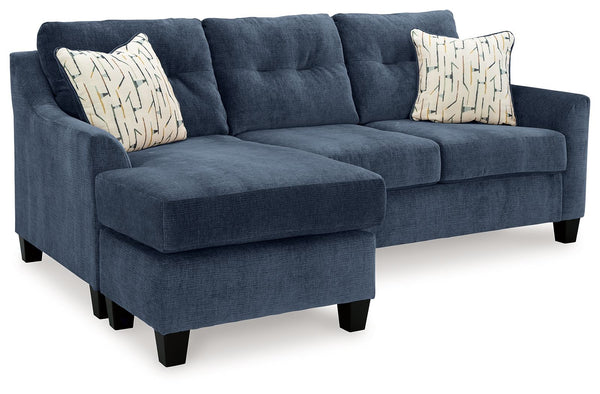  finesses the set with just the right touch. Gently flared arms and tufted back cushions let you ba