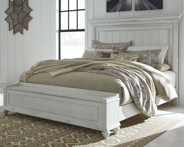 Give your retreat vintage charm with this California king panel bed with storage bench footboard. In a beautifully distressed whitewash finish, you-'ll love the headboard-'s grand style featuring a picture framed panel. The bench footboard is equally eleg