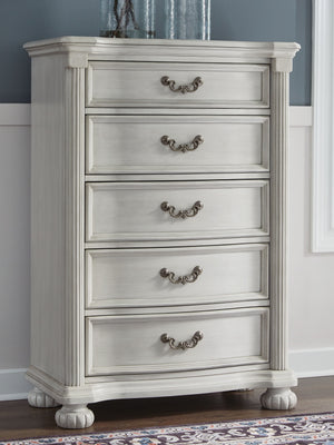  highlighted by a serpentine-shaped front with thick decorative moulding. Its drawer