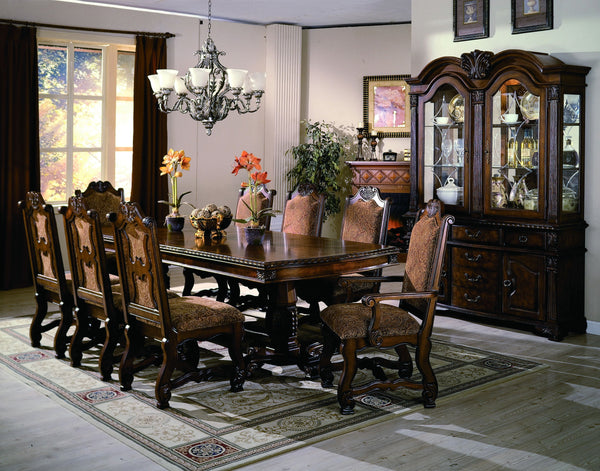 Elevate your dining space with the timeless elegance and grandeur of this exquisitely crafted dining group. Featuring a beautifully carved table with intricate detailing and a stately double pedestal base, this set exudes classic European-inspired charm. 