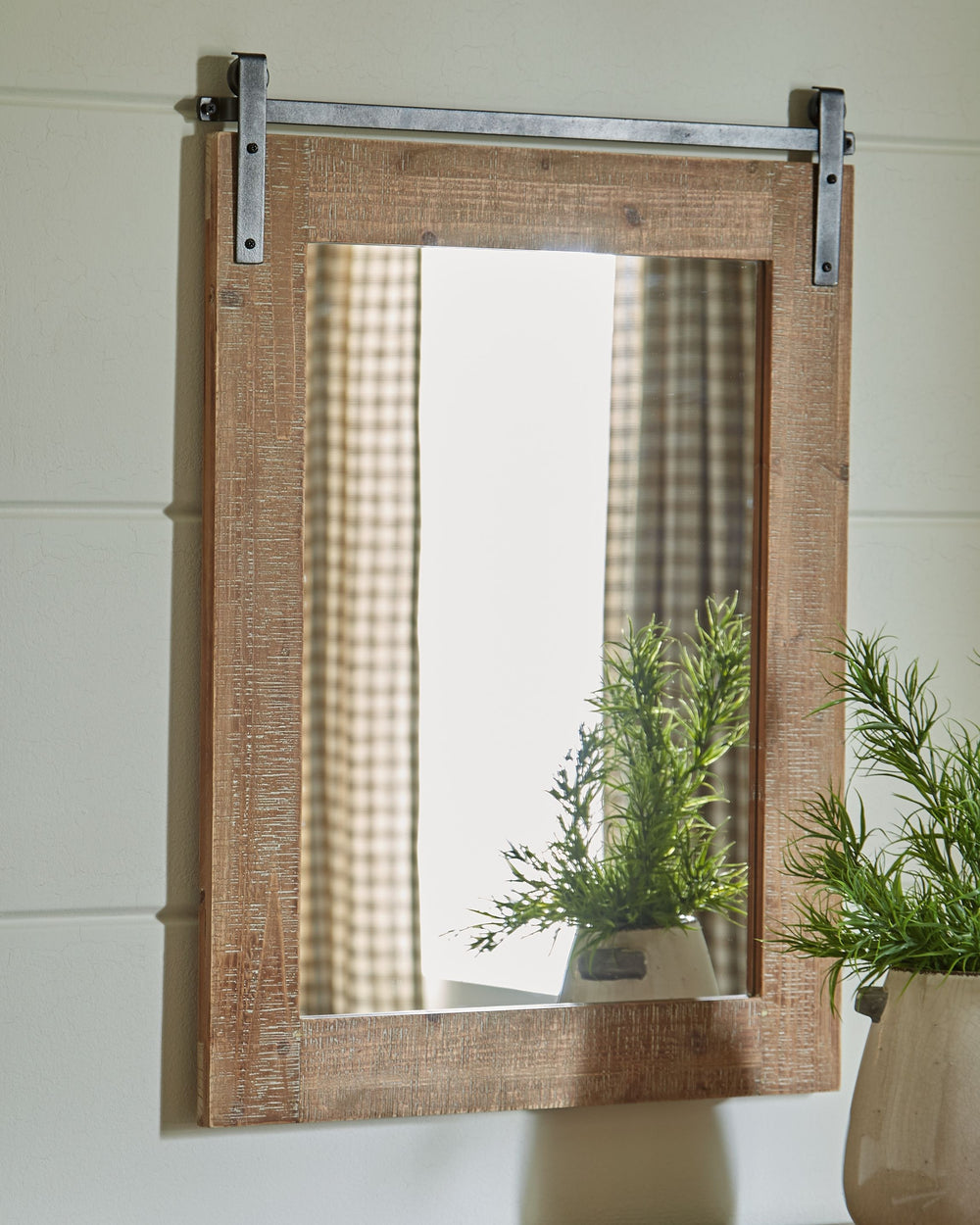 Getting the casual yet complete look you love is a breeze with this accent mirror. With its antiqued brown finished and rough sawn wood, this accent mirror features a black finished metal faux barn door track adding a touch of warmth to any space.<br><br>