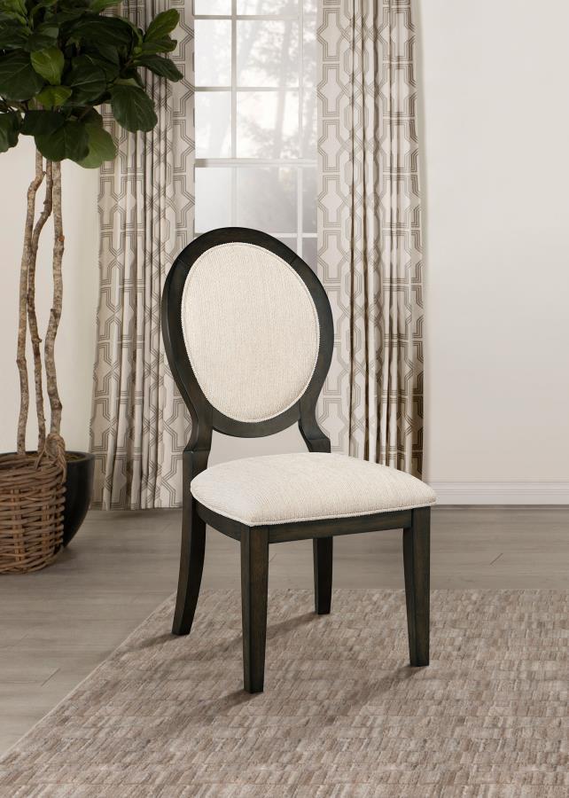 Elegant curves and contrasted finishes collide in this transitional side chair. A lovely addition to a dining space, this stunning chair can be slid up to a table for a comfortable place to sit over a long dinner, inviting you to lean back against its pad