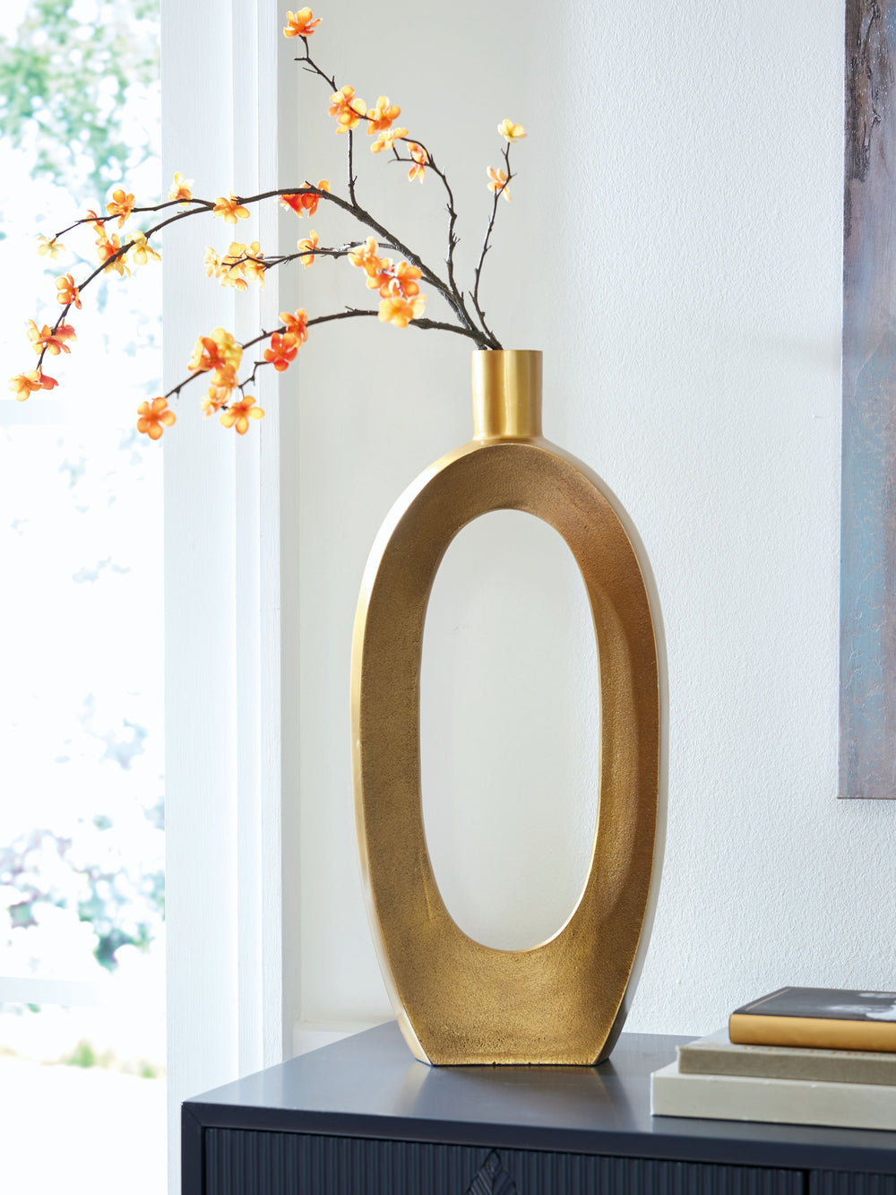 Geometric forms get a glam upgrade in this vase. Decidedly contemporary with its sculptural silhouette, it ushers a confidently curated vibe into your space. The goldtone finish brings an eye-catching metallic flair to your mantel, bookshelf or centerpiec