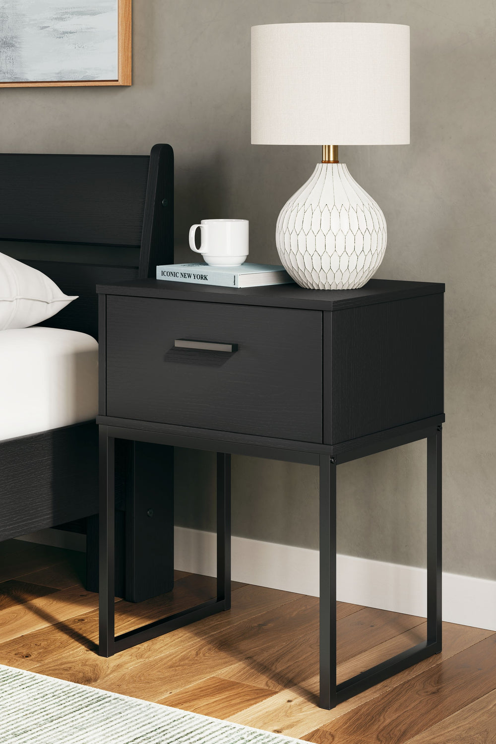 Warm and alluring, this nightstand is inspired by chic design. A matte black finish and dark pewter-tone handles offer an elegant touch to this so-cool piece. It beautifully blends the hues of natural living with the edginess of your modern lifestyle.<br/